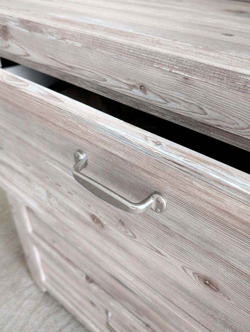An open wooden drawer, quietly holding something kept over time.