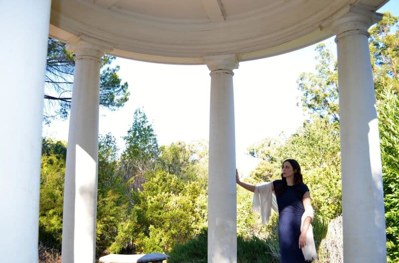 Stephanie Field standing beneath a circular colonnade, reflecting on beauty, craftsmanship, and enduring traditions.